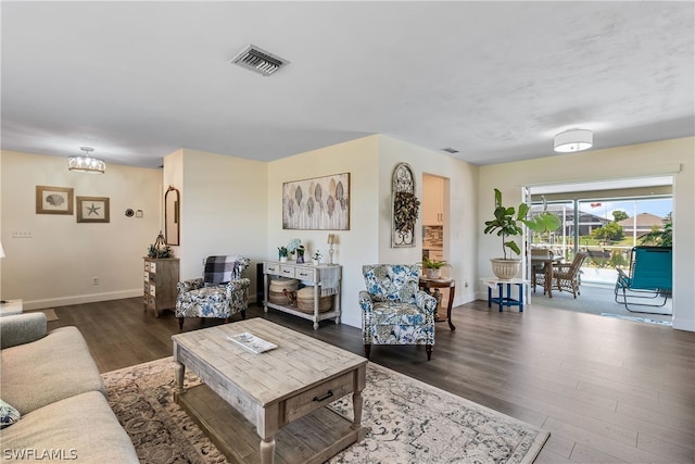 living room featuring dark hardwood / wood-style floors and a chandelier