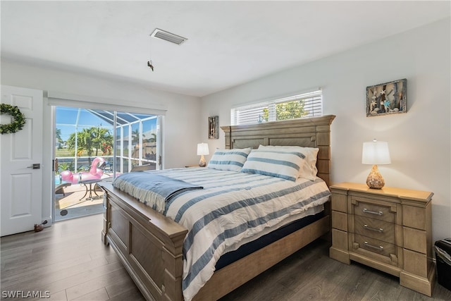 bedroom with access to exterior and dark wood-type flooring