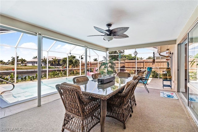 sunroom / solarium featuring ceiling fan and plenty of natural light