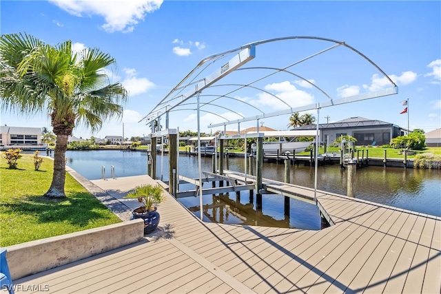 view of dock featuring a lawn, a water view, and a lanai