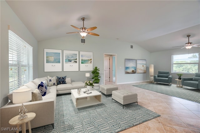 living room featuring ceiling fan, light tile patterned flooring, and vaulted ceiling