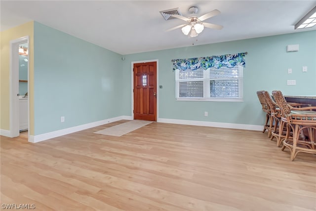 foyer entrance featuring wood-type flooring and ceiling fan