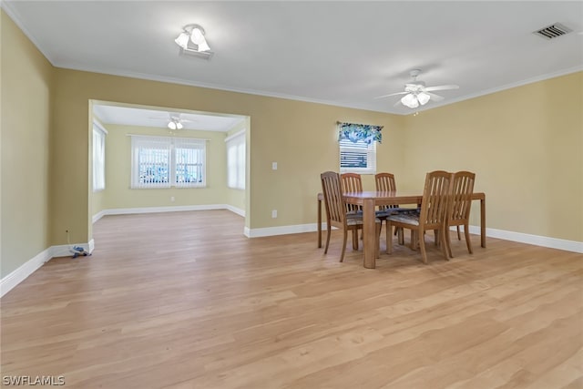 dining area with ornamental molding, light wood-type flooring, and ceiling fan