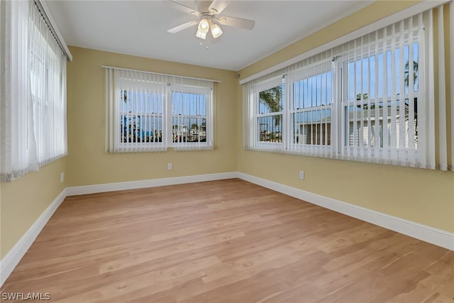 spare room with ceiling fan and light wood-type flooring