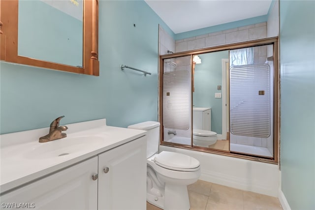 full bathroom featuring tile floors, large vanity, combined bath / shower with glass door, and toilet