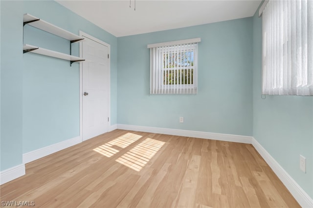 empty room with light hardwood / wood-style flooring