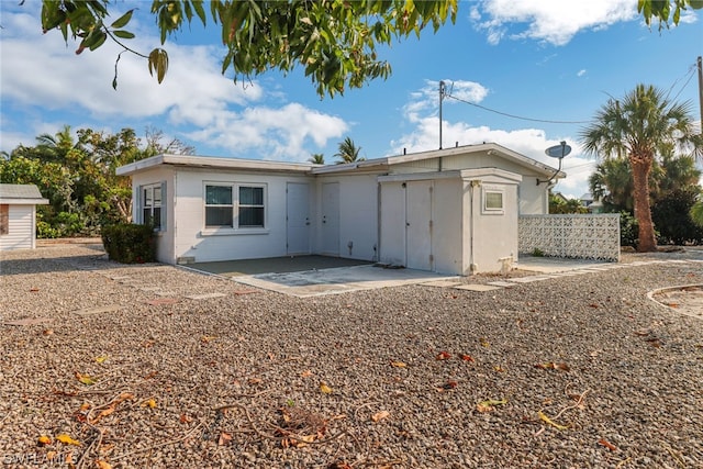 back of property with a patio area