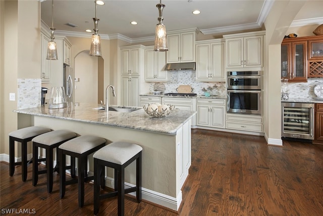 kitchen with tasteful backsplash, light stone counters, stainless steel appliances, wine cooler, and dark hardwood / wood-style flooring