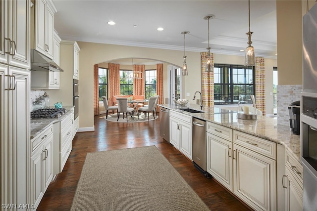 kitchen featuring dark hardwood / wood-style flooring, decorative light fixtures, sink, and light stone countertops