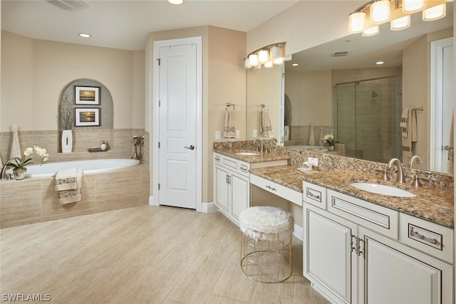 bathroom featuring independent shower and bath, tile flooring, dual sinks, and oversized vanity