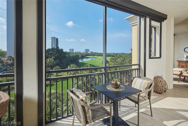 sunroom / solarium featuring a water view and a healthy amount of sunlight