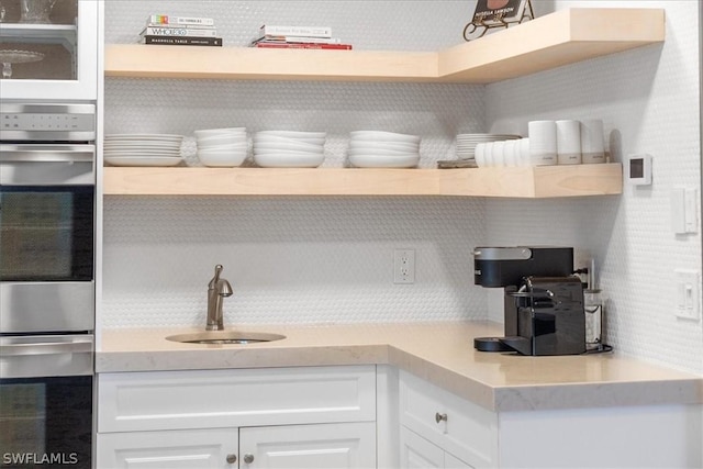 kitchen featuring white cabinets and sink