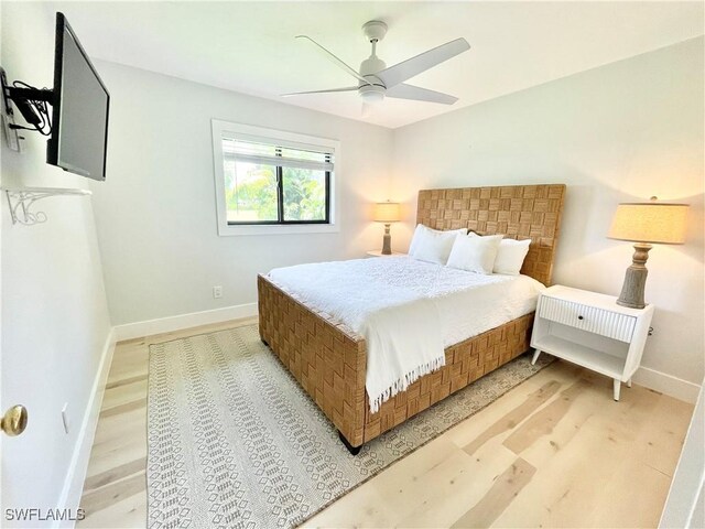 bedroom with ceiling fan and light wood-type flooring