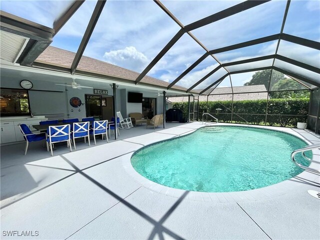 view of pool featuring ceiling fan, a patio, and glass enclosure