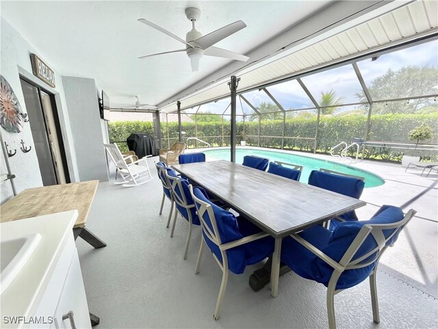 view of patio / terrace featuring a fenced in pool, glass enclosure, and ceiling fan