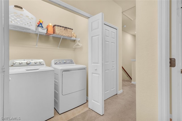 clothes washing area featuring separate washer and dryer and light carpet