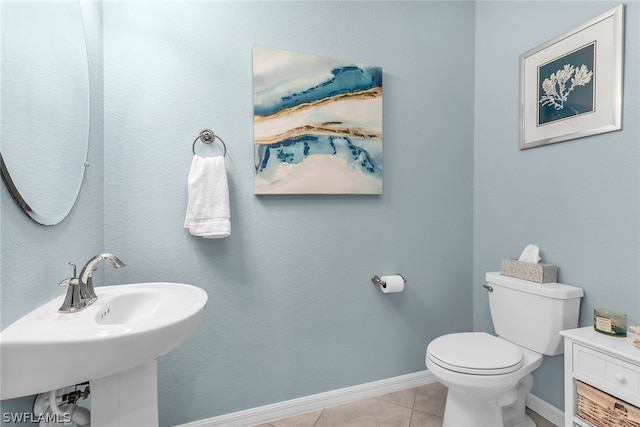 bathroom featuring sink, tile floors, and toilet