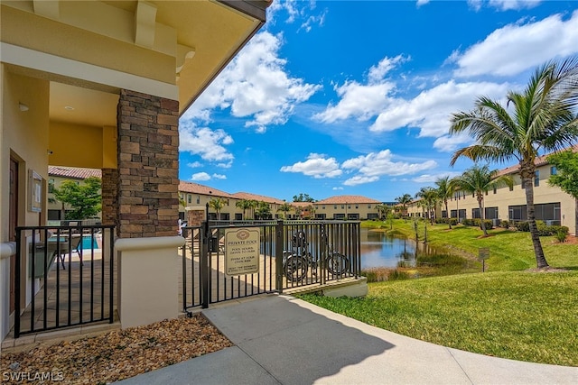 exterior space with a water view and a lawn