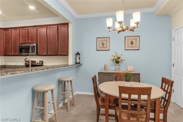 dining area featuring a chandelier, crown molding, and light carpet