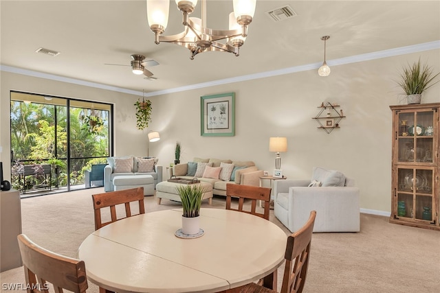 carpeted dining space with ornamental molding and ceiling fan with notable chandelier