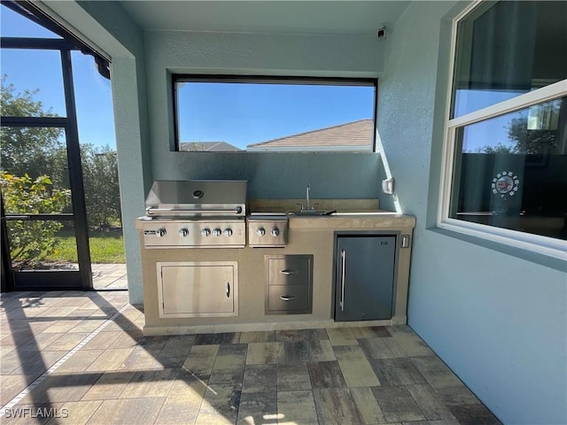 view of patio featuring sink, grilling area, and an outdoor kitchen