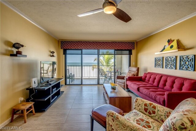 living room featuring ceiling fan, crown molding, and a textured ceiling