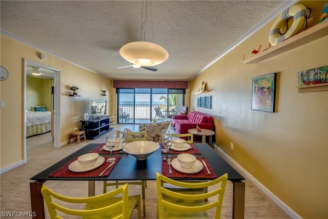 dining room with a textured ceiling and ornamental molding