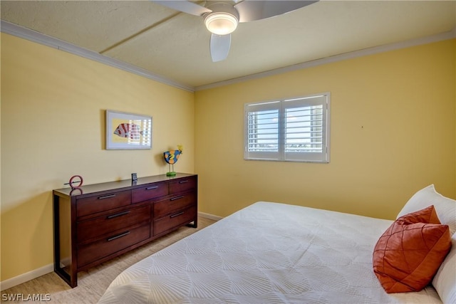 bedroom with ceiling fan and crown molding