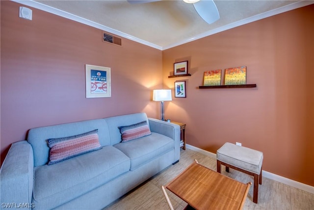 living room with ceiling fan and ornamental molding