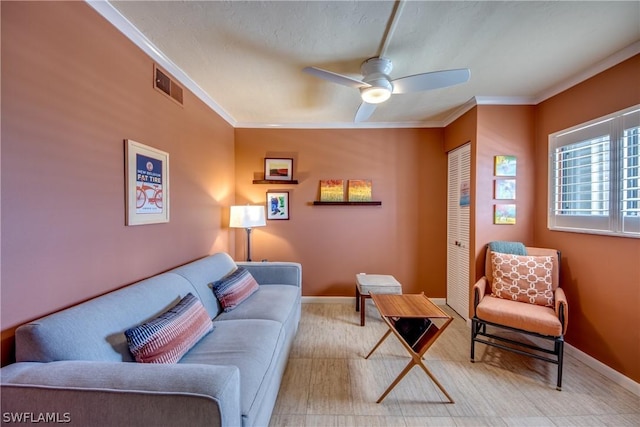 living room with ceiling fan and crown molding