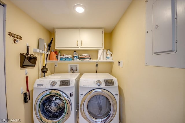 clothes washing area featuring cabinets, independent washer and dryer, and electric panel