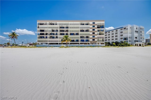 view of building exterior with a view of the beach and a water view