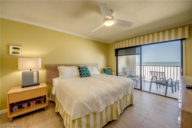 bedroom with ceiling fan, access to exterior, a textured ceiling, and crown molding