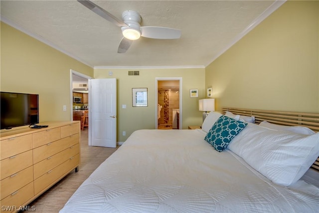 bedroom with ceiling fan, crown molding, connected bathroom, and light hardwood / wood-style flooring