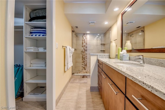 bathroom featuring vanity and tiled shower