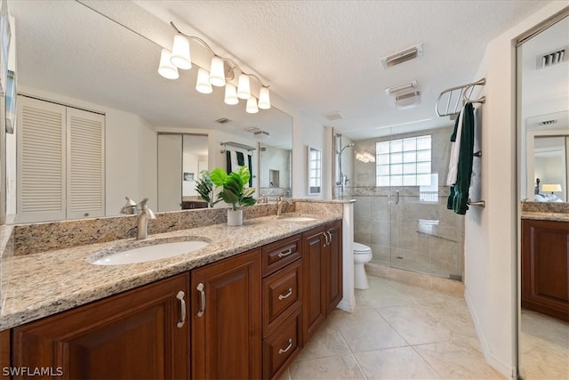 bathroom featuring walk in shower, tile patterned floors, a textured ceiling, toilet, and vanity