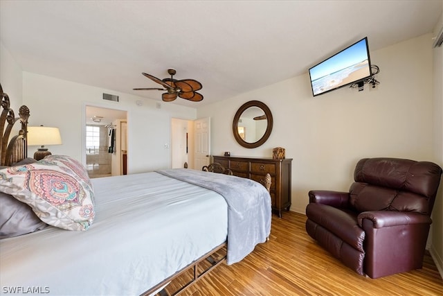 bedroom with ceiling fan, light hardwood / wood-style floors, and ensuite bathroom