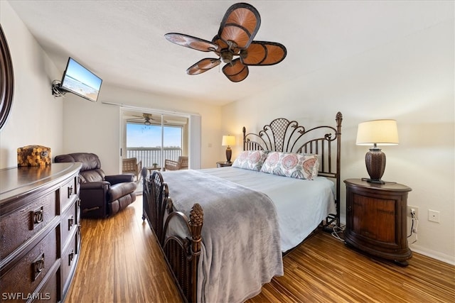 bedroom with access to outside, ceiling fan, and hardwood / wood-style floors