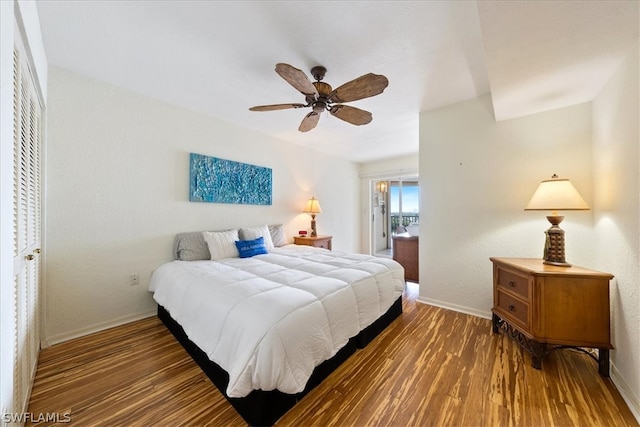 bedroom featuring ceiling fan, a closet, and dark hardwood / wood-style floors