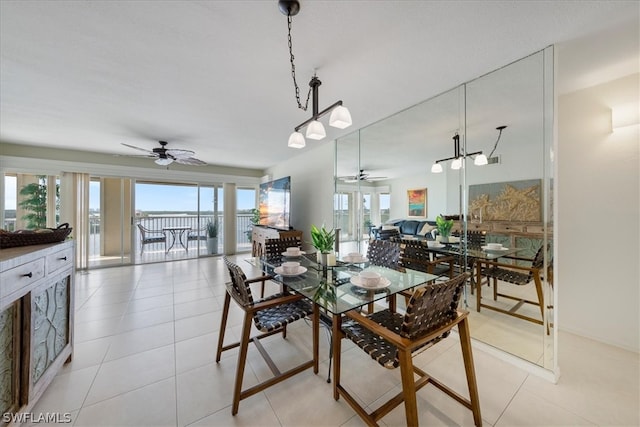 tiled dining space featuring ceiling fan