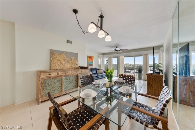 tiled dining space featuring ceiling fan