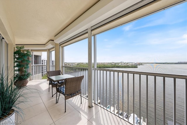 sunroom / solarium featuring a water view