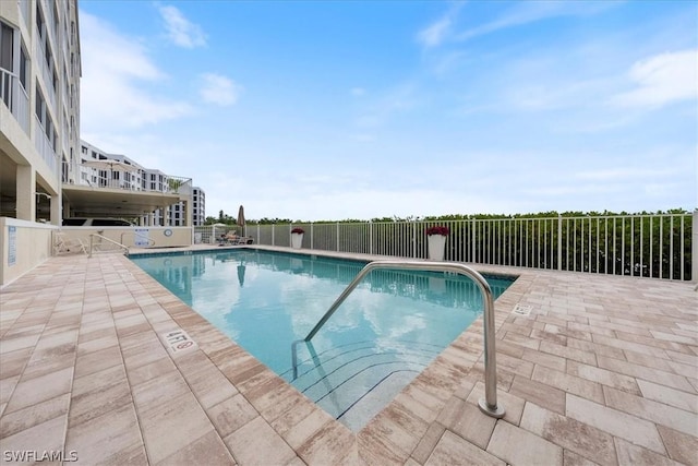 view of swimming pool with a patio