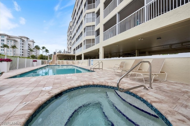 view of pool with a community hot tub and a patio