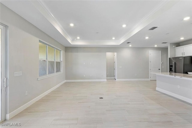 12445 Basalt Ln, Alva, FL 33982 - unfurnished living room featuring ornamental molding, a tray ceiling, baseboards, and recessed lighting