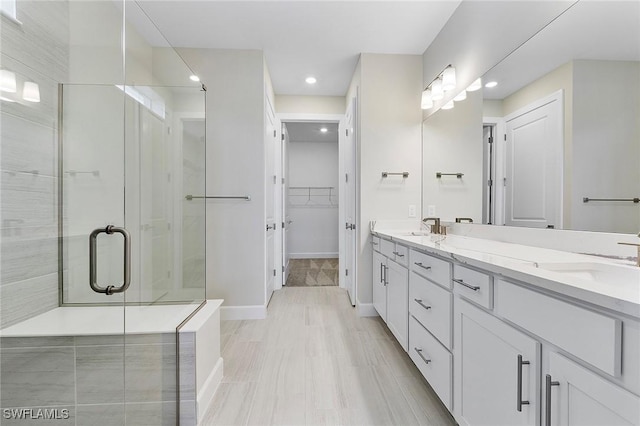 12445 Basalt Ln, Alva, FL 33982 - full bathroom with double vanity, a shower stall, recessed lighting, baseboards, and a spacious closet