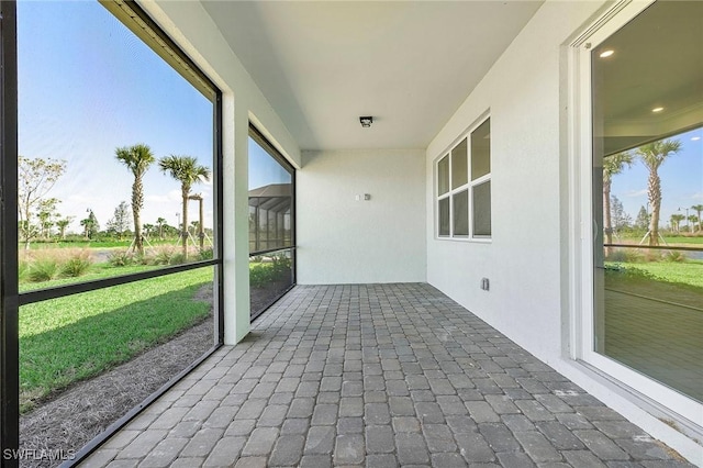 12445 Basalt Ln, Alva, FL 33982 - unfurnished sunroom featuring healthy amount of natural light and brick flooring