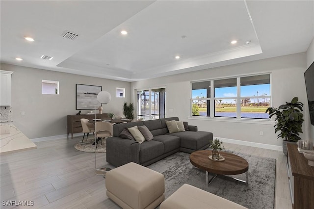 12445 Basalt Ln, Alva, FL 33982 - living area featuring a raised ceiling, light wood finished floors, healthy amount of natural light, and recessed lighting