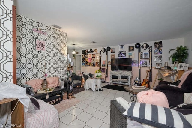 tiled living room with a notable chandelier