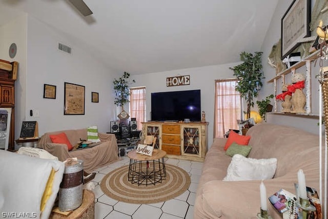 living room featuring high vaulted ceiling, light tile floors, and a wealth of natural light